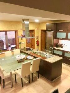 a kitchen with a table and chairs and a kitchen with a counter at Villa Bessa Nature & Spa in Fafe