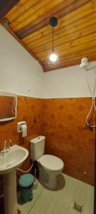 a bathroom with a toilet and a sink at Contos de Alice in Tiradentes +26 photos