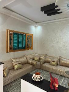 a living room with a couch and a table at Villa Basmat in Oualidia +7 photos