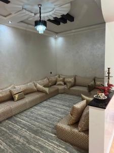 a living room with a large couch and a table at Villa Basmat in Oualidia