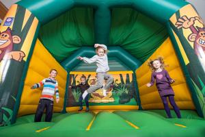 a group of children jumping in a play structure at Spidsbergseter Resort Rondane in Venabygd