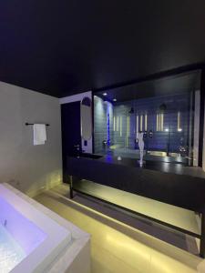 a bathroom with a sink and a large mirror at Khalifa Experience Motel in Itumbiara