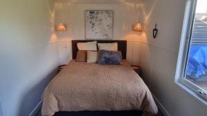 a small bedroom with a bed in the corner at The waterfront retreat in Lock Sport