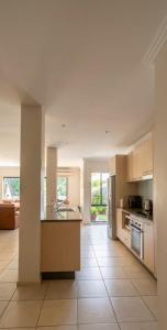 a large kitchen with a large tile floor at Penguins by the Beach in Cowes