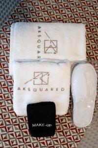 a pair of towels with a soap and a tag at AKSQUARED Premium Vacation Apartments in Paralia Dionysiou +19 photos