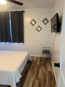 a bedroom with a bed and a television on the wall at West Mitchell in Phoenix