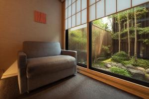 a chair in a room with a large window at MR T Kamogawa East 12 in Kyoto