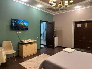 a bedroom with a bed and a sink and a mirror at Dostyq in Astana