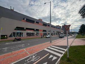a street with a building on the side of a road at Novaterra Cerezo in Mosquera