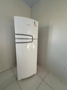 a white refrigerator in a corner of a room at Apt Serras Gerais Superior in Dianópolis