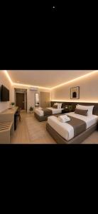 a hotel room with two beds and a desk at tyty cairo hotel in Cairo