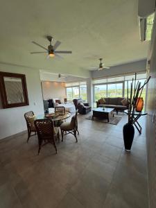a living room with a couch and a table and chairs at departamento 314 in Nuevo Nayarit