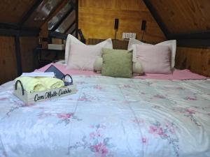 a large bed with a sign on it at Cabana recanto da TOCA in Ilhabela +26 photos