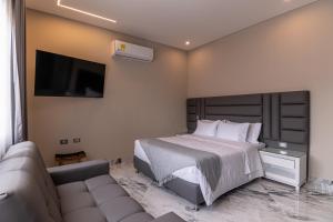 a bedroom with a bed and a couch and a tv at Hotel Colores Estadio in Medellín +85 photos