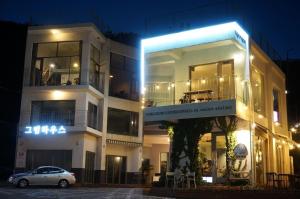 a car parked in front of a building at night at Greemhouse in Busan +3 photos