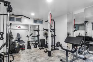 a gym with a lot of equipment in a room at The Pines Men-Only Stay in Fire Island Pines