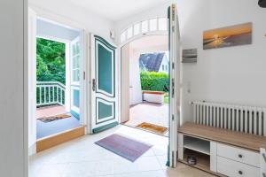 a hallway with a door leading to a balcony at Villa-Magnolia-H in Hohwacht