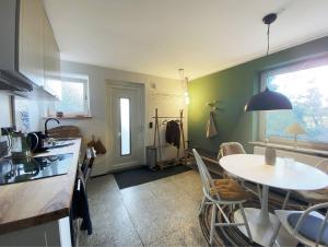 a kitchen with a table and a dining room at AHOI-MARIE in Blekendorf