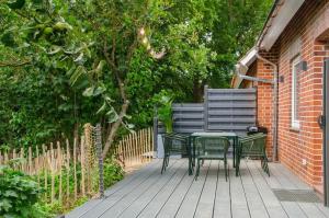 a table and chairs sitting on a patio at AHOI-MARIE in Blekendorf