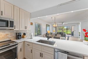 a kitchen with a sink and a counter top at Spacious 2BR 2BA apartment close to the beach in Jupiter
