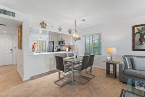 a dining room and living room with a table and chairs at Spacious 2BR 2BA apartment close to the beach in Jupiter