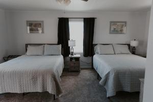 a bedroom with two beds and a window at The Last Resort in Sault Ste. Marie
