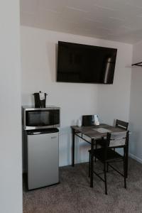 a room with a table and a microwave and a table with a table at The Last Resort in Sault Ste. Marie