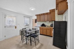 a kitchen with a table and chairs in a kitchen at Charming 2-Bedroom, 1-Bath Getaway in Carbondale