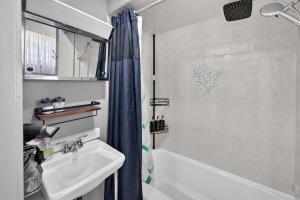 a bathroom with a tub and a sink and a shower at Charming 2-Bedroom, 1-Bath Getaway in Carbondale +13 photos