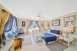 a living room with a bed and a couch at Hidden Gem Barbados in Christ Church +18 photos