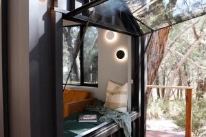 a room with a window in a tree house at SHAK Halls Gap - Off Grid Tiny Home in Halls Gap