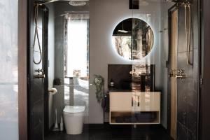 a bathroom with a toilet and a mirror at SHAK Halls Gap - Off Grid Tiny Home in Halls Gap