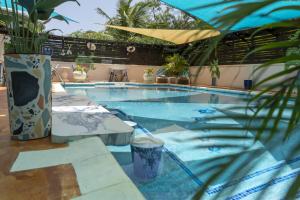 a large swimming pool with a table and chairs at Hidden Gem Barbados in Christ Church