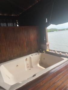 a large white bath tub in a boat on the water at Villa Bahia Del Sol in Bocas Town +44 photos