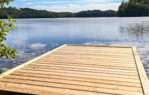 a wooden dock on a large body of water at 3 Bedroom Gorgeous Home In Ullared in Ullared