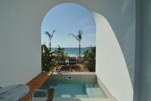 a swimming pool in a house with a view of the ocean at Hotel Camelot By Artur in Ksamil