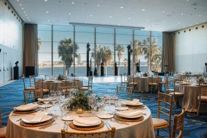 a banquet hall with tables and chairs and a large window at W Barcelona in Barcelona