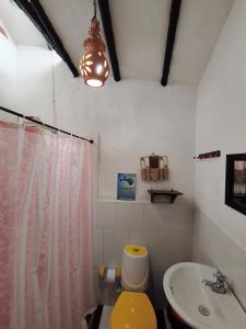 a bathroom with a yellow toilet and a sink at Cabañas Cañon Del Chicamocha in Aratoca +75 photos