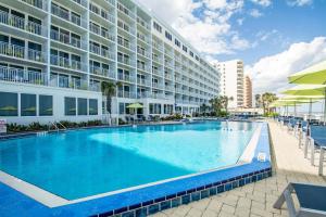 a large swimming pool in front of a building at Hilton Vacation Club Daytona Seabreeze Daytona Beach in Daytona Beach