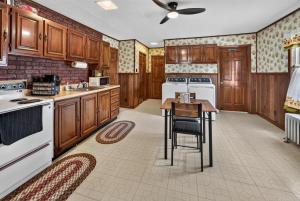 a kitchen with wooden cabinets and white appliances at 1-Bedroom, 1-Bath Getaway in Carbondale +13 photos