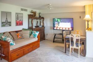 a living room with a couch and a table at Jupiter Bay Beach Condo in Jupiter