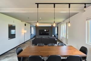 a living room with a table and a couch at Aoyagi Stay in Shiomichō