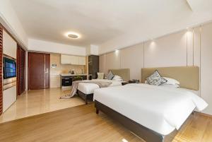 a hotel room with two beds and a kitchen at RoomMe HOTEL寓洣公寓佛山铂顿祖庙岭南天地店 in Foshan +67 photos