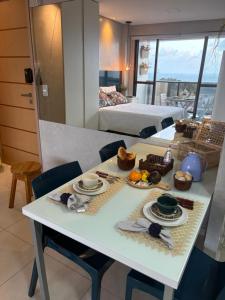 a white table with food on it in a room at STUDIO Mar azul 1206 in São Luís