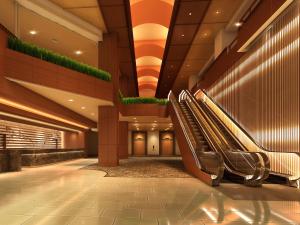 a lobby with escalators in a hotel at ANA Crowne Plaza Kochi by IHG in Sagamichō