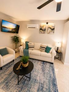a living room with two couches and a table at The Arlington Hideaway in Jacksonville