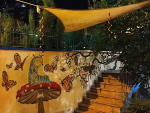 a staircase with butterflies painted on the side of a wall at Villa Villekulla in Tirana