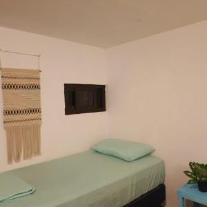 a white room with a bed and a window at El Puente in El Paredón Buena Vista