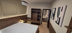 a room with a bed and some pictures on the wall at Drei Schweizer Hotel in Neuwied