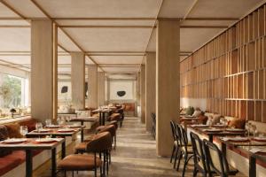 a dining room with tables and chairs and windows at DoubleTree by Hilton Madrid Principe de Vergara in Madrid